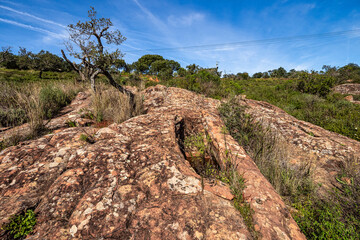Granite rock cut anthropomorphic grave in Vale Fuzeiros at Vilarinha, Algarve, Portugal.
