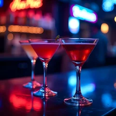 Martini glasses at a vibrant neon bar