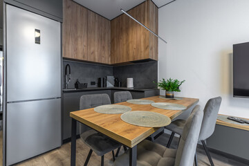 L-Shaped Kitchen with Dining Table and TV Area
