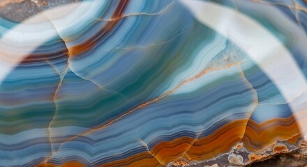 Macro view of a colorful agate gemstone with intricate blue and orange bands.
