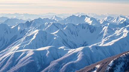 Obraz premium Snowy mountain peaks with a vast winter landscape under a sky.