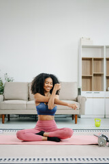 Woman Doing Yoga and Watching Online Tutorials on Laptop, Training in Living Room at home
