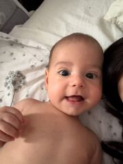 Smiling Baby on Floral Sheets