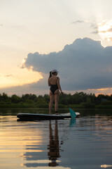 Paddleboarding at Sunset on a Tranquil Lake