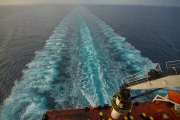 View of the stern of a merchant ship at sea in the morning