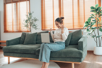 Funny euphoric young asian woman celebrating winning or getting ecommerce shopping offer on computer laptop. Excited happy girl winner looking at notebook celebrating success