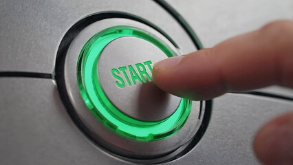 Finger pressing a start button with the text "Start" and green light, Pushing power button. Technology, Energy and Innovation	