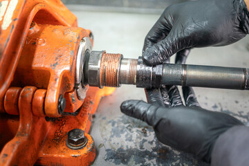 A serviceman is lube lubricant or thread protection chemical on the equipment's thread which is...