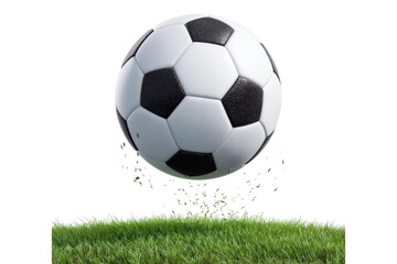 Fototapeta premium Classic black and white soccer ball bouncing on green grass with flying turf