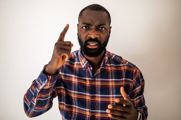 Close up portrait of angry black man who threatens.