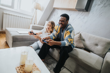 A cheerful moment with a diverse couple playing video games in a modern home setting, illustrating joy, leisure, and togetherness.