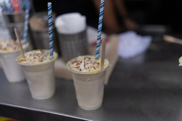 Traditional Mango Lassi with Almond Topping at Old Delhi Street Vendor Stall, India