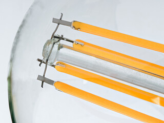 Macro shot of LED Filament type lamp on white background