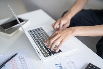 Business man working using laptop computer Hands typing keyboard. Professional investor working start up project. business planning in office. Technology business Concept