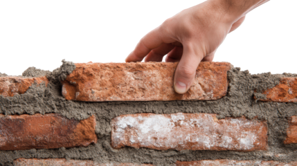 Closeup of hand adjusting brick level on wet mortar, showcasing craftsmanship involved in masonry work. image captures texture of bricks and mortar, emphasizing skill required in construction