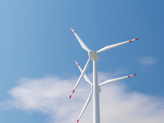 Low-angle view of a wind turbine with red-tipped blades in the sky.