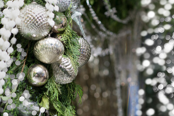 Elegant silver christmas decorations with bokeh and fir tree branch. Silver festive background