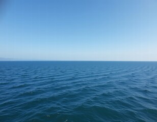 Endless Blue Horizon Over Tranquil Ocean Water with Gentle Ripples Under Clear Sky on a Calm Day