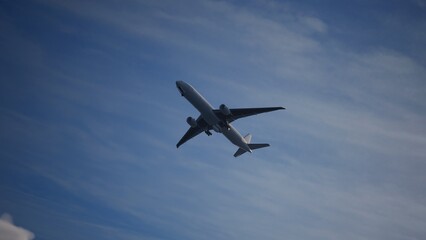 Airplane in the sky, over the cloudy sky