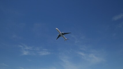 Airplane in the sky, over the cloudy sky