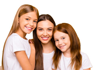 Three pretty ladies of different age hugging each other with love wear casual white t-shirts isolated yellow background