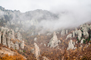 Striking rock formations rise through misty envelope in crimean mountains. Natural landscape...