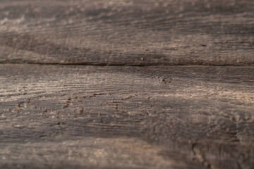 Close-up background. old textured wood board dark brown color in streaks.