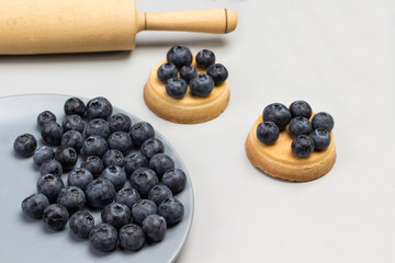 Blueberries on gray plate. Blueberry tartlets