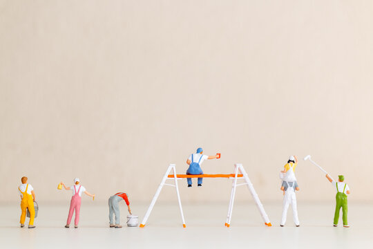 Miniature Painters at Work on Blank Wall