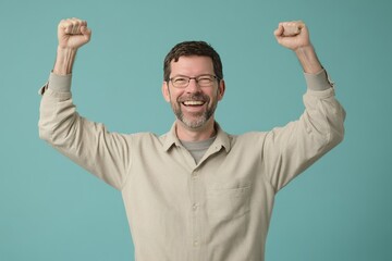 A middle-aged man of light complexion  is celebrating . His arms are raised high in the air, fists clenched in a celebratory pose, and his mouth is open in a wide, joyful expression