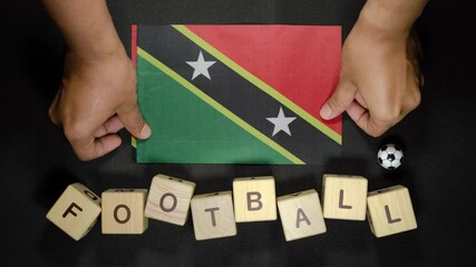 Saint Kitts and Nevis flag with football title. football concept