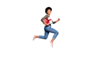 Full size photo profile side of dreamy curly hair mulatto girl hold gift box dream jump run to best friend 8-march celebration party wear green pullover denim jeans isolated blue color background
