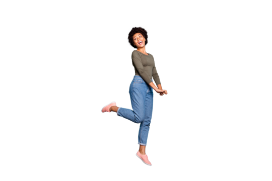 Full length body size photo of cheerful cute charming nice jumping black millennial girlfriend excited with compliment wearing jeans denim green sweater isolated over blue vivid color background