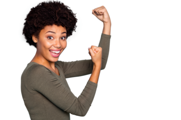 Photo of cheerful positive cute sweet black youngster demonstrating you her biceps muscles rejoicing isolated over blue vivid empty space color background