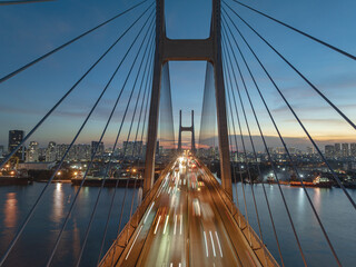 Phu My bridge glows under twilight in Ho Chi Minh City, showcasing the vibrant urban skyline