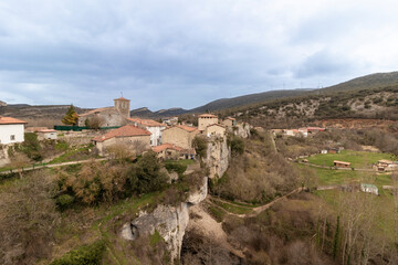 Medieval village perched on cliff overlooking valley in spain