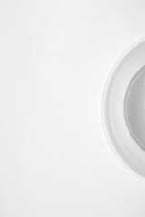 White minimalism with plastic plate and cup on a light background. Simple and balanced composition, ideal for themes of design, consumption, single-use waste, or environmental sustainability.
