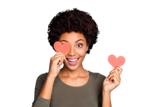 Close up photo of amazed excited emotions afro american girl hold little paper card close cover her face have fun on date for 14-february wear green sweater isolated over blue color background