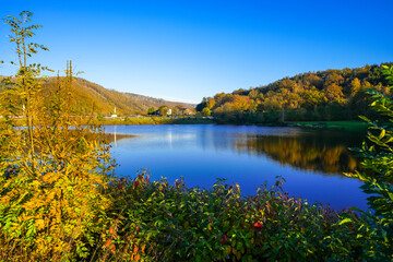 View of the Eiserbachsee lake in Rurberg near Simmerath. Landscape at the Eiserbach dam. Nature in the Eifel region.

