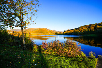 View of the Eiserbachsee lake in Rurberg near Simmerath. Landscape at the Eiserbach dam. Nature in the Eifel region.

