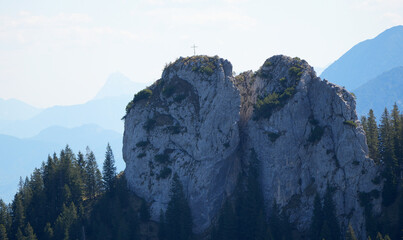 Majestic Ettaler Manndl mountain peak with a summit cross in the Alps