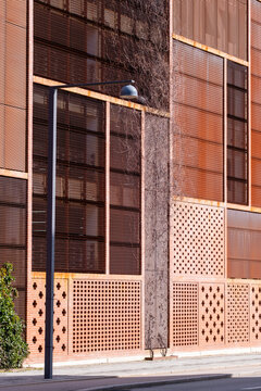 Textured facade with perforated panels, geometric lines and patterns, contemporary architecture, urban design, background for visual concepts.