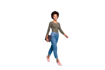 Full size photo of positive confident independent cool dark skin girl freelancer go walk for job in company hold her netbook wear casual style clothes pink sneakers isolated blue color background