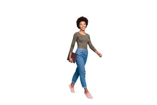 Full size photo of positive confident independent cool dark skin girl freelancer go walk for job in company hold her netbook wear casual style clothes pink sneakers isolated blue color background