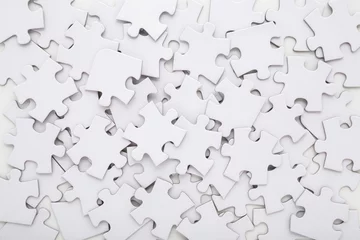 Selbstklebende Fototapeten Different many white puzzle pieces background. Closeup. Top down view. © fotoduets