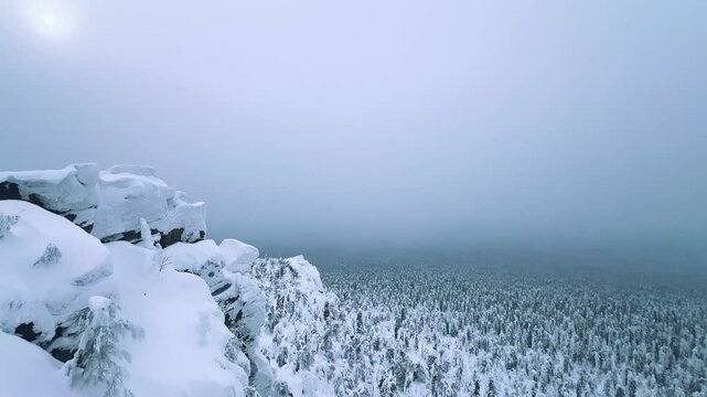 View of the white rocks and the winter forest on Mount Polyud. Lappish spruces on Mount Polyud in the Perm region in winter. In winter, there is a lot of snow and frost on the trees in the Urals. 4К