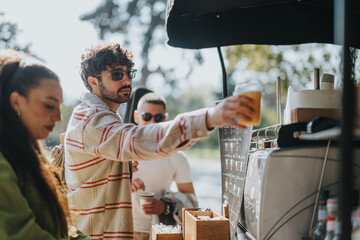 A group of friends enjoying drinks at a coffee stand in a sunny outdoor setting, showcasing relaxation and socializing in a vibrant atmosphere.
