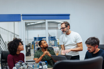 Engineers collaborating on innovative project in modern factory office