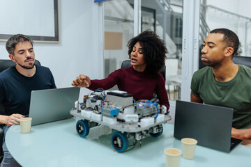 Robotics engineers collaborating on innovative design project with prototype