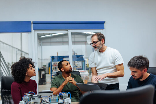 Engineers collaborating on innovative project in modern factory office